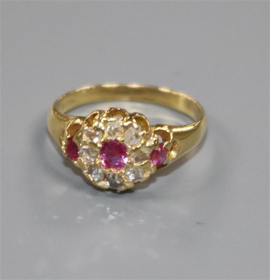 A small early 20th century ruby and rose cut diamond set cluster ring, size G.